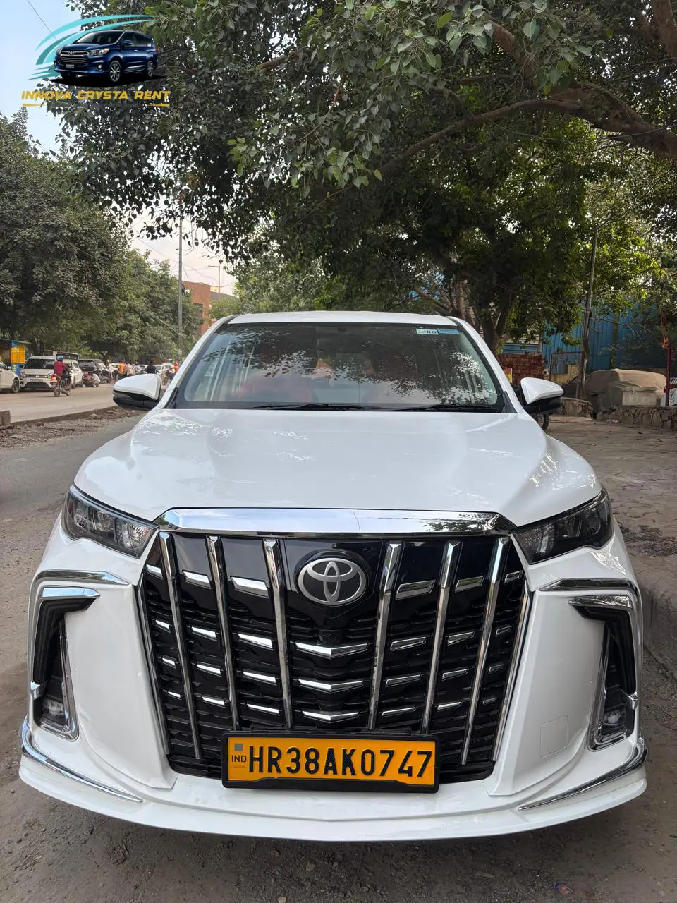 White Toyota Innova Crysta rental in Delhi front view with luxury exterior design