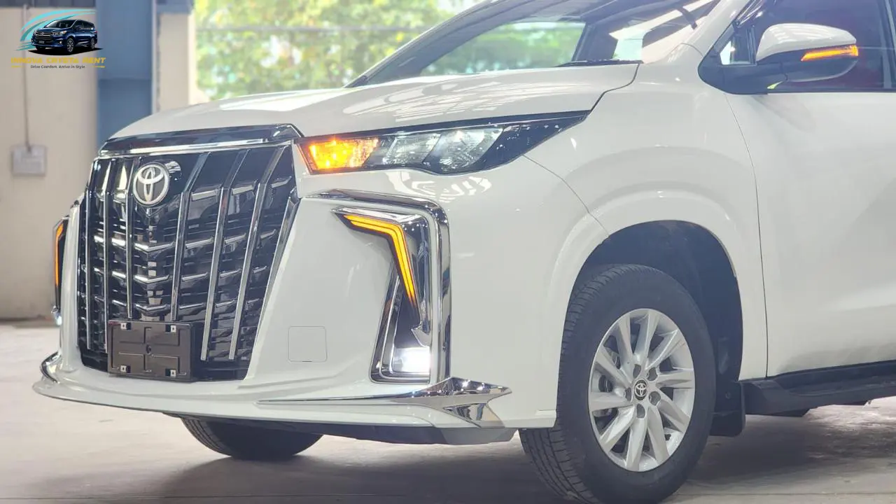 White Toyota Innova Crysta side front exterior with LED DRLs available for rent
